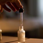 Dropper, bottle, oil — London massage outcall for clients seeking private and comfortable massage services