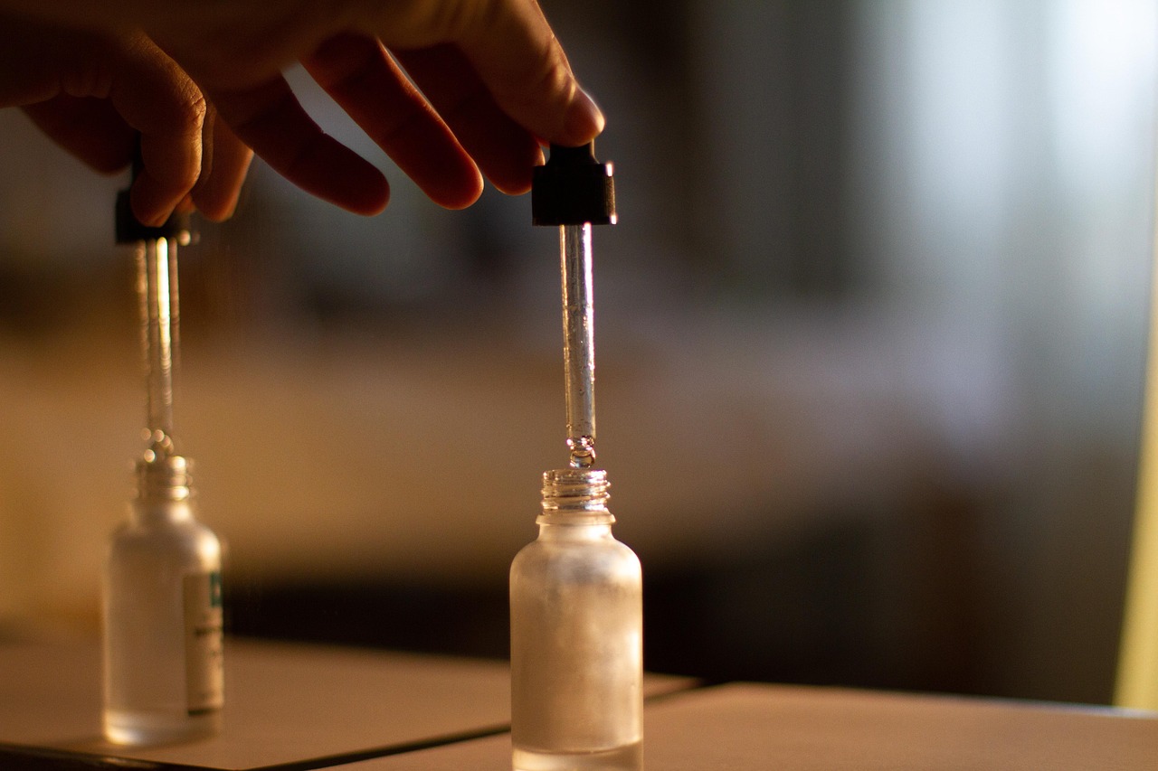 Dropper, bottle, oil — London massage outcall for clients seeking private and comfortable massage services